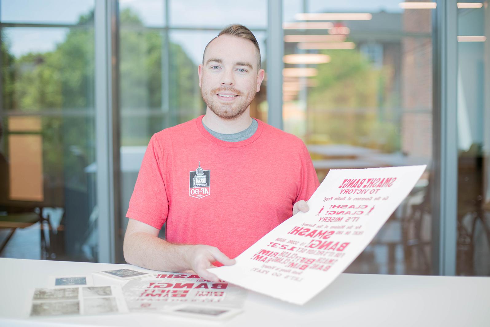 Patrick Gosnell poses with print